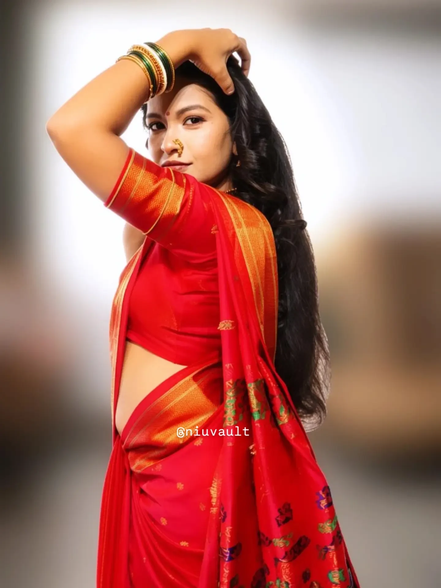 Long hair styled loose and brushed out, worn with a traditional red saree